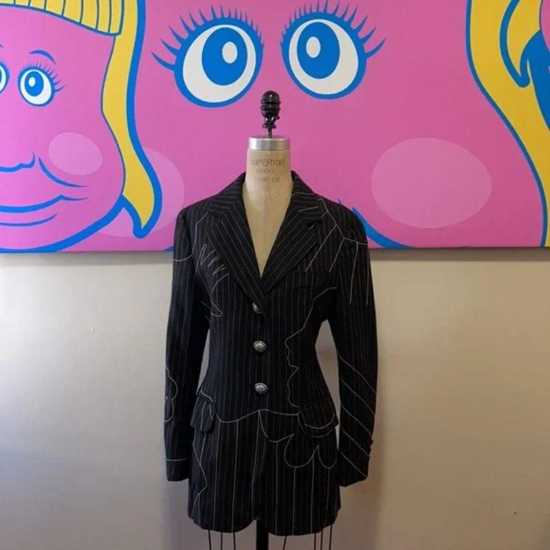 Moschino cheap chic foot hands face pinstripe blazer

Vintage is all the rage and this 1990s wool blazer with embroidered face, and foot and sun is a great example of what makes vintage so great. A wearable today as when it was made. Pair with white