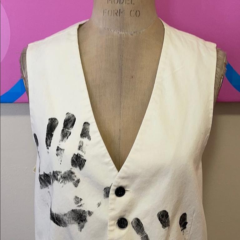 Moschino cheap & chic hand print painters vest

Be retro cool wearing this vintage vest by Moschino. Made of painters drop cloth material with a unique hand print design. HAND PAINTED on the back with palm print in black. Pair with V neck t-shirt,