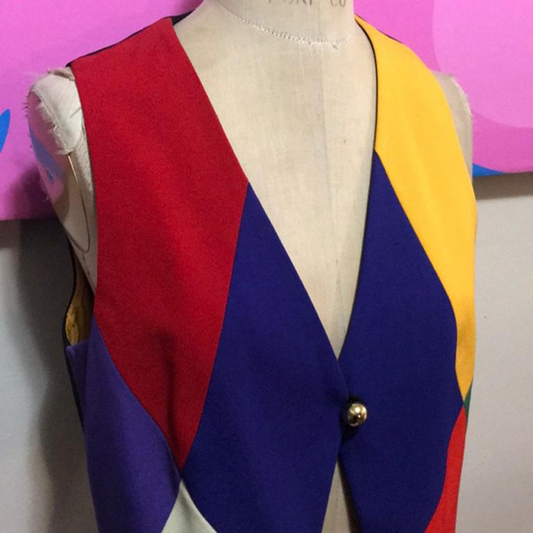 Moschino cheap chic harlequin vest

Iconic Moschino ! This vest is perfect for special occasion dressing - pair with black skinny pants and boots over a long sleeve blouse ! Brand runs small. 
Size 8
Across chest - 18 1/2 in.
Across waist -  17