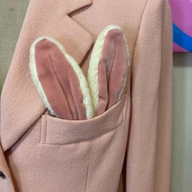Moschino cheap chic pink bunny blazer jacket

Moschino Couture's sense of humor is evident in this pink wool crepe blazer with adorable pink velvet bunny ears in the pocket and white puff bunny tail on the back. Perfect for special occasion
