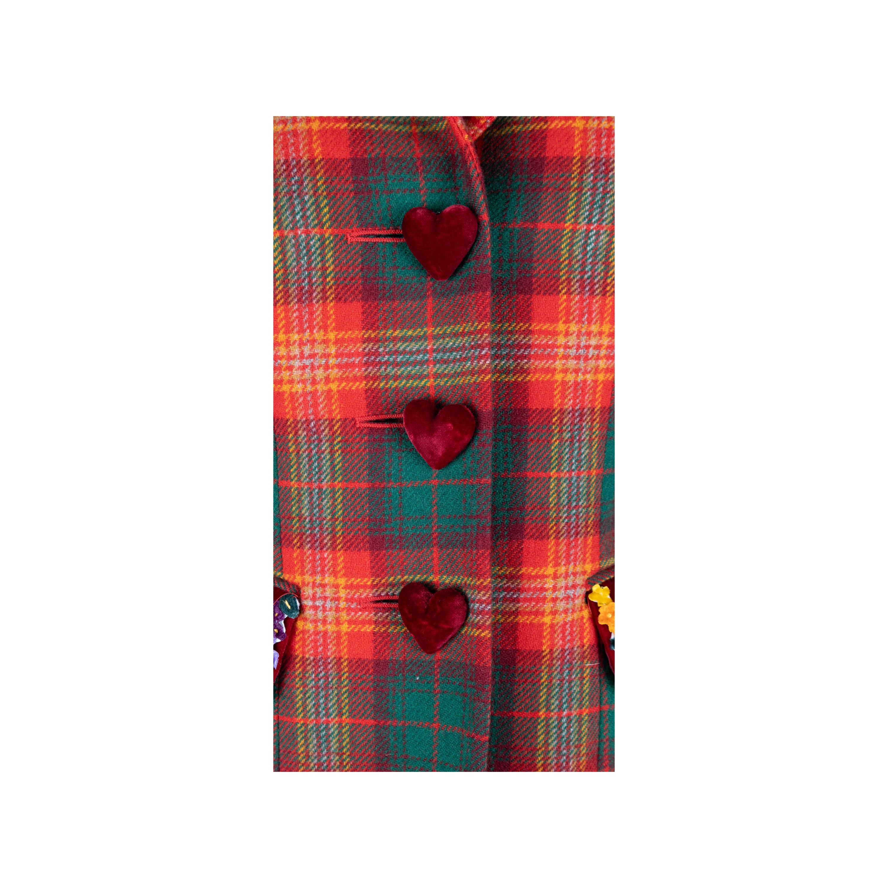This vintage Moschino Cheap & Chic jacket is crafted from premium wool and detailed with sumptuous velvet inserts and heart shaped buttons. The iconic 90s plaid tartan jacket is finished with a bow at the back for a look that is both chic and