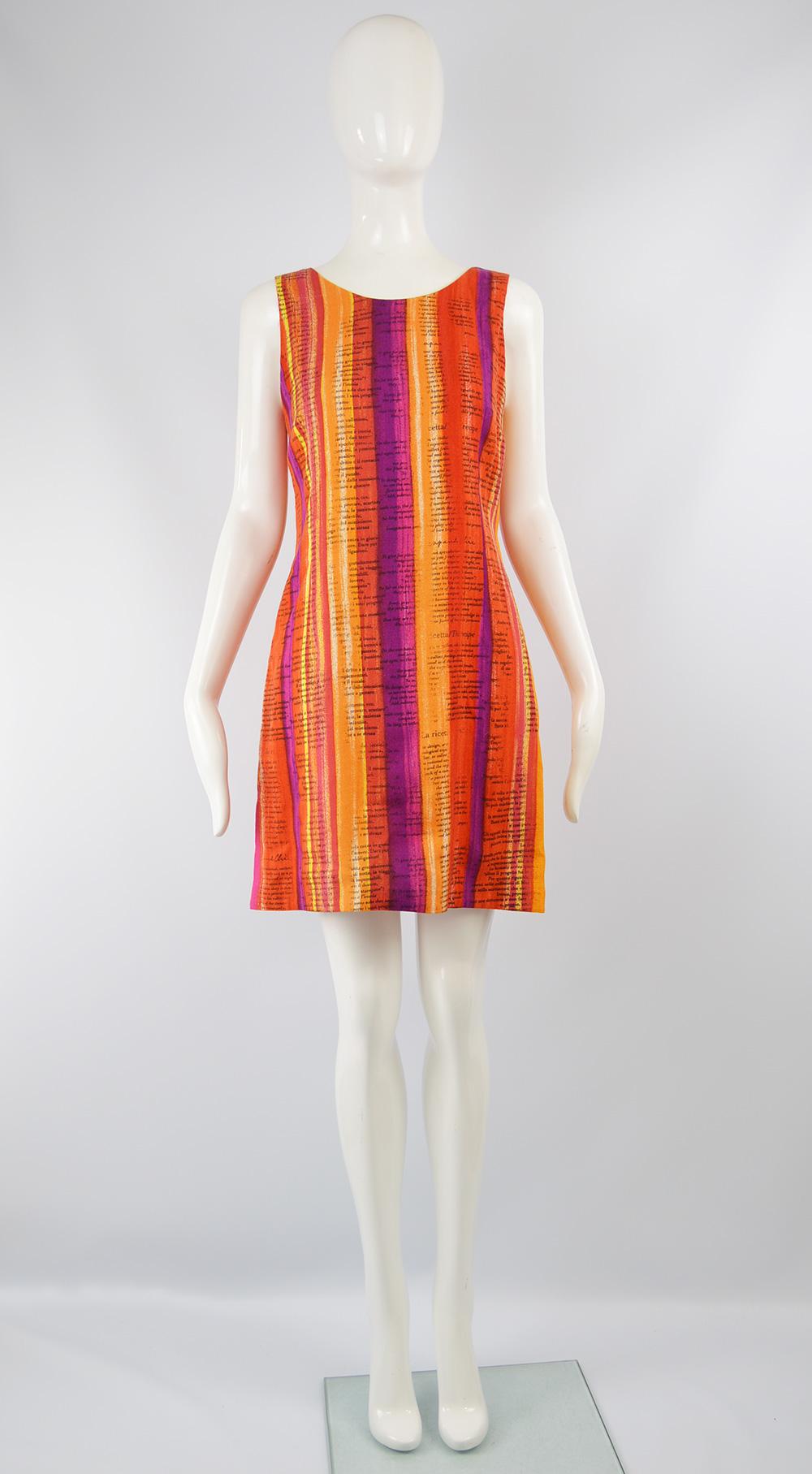 A bold and fun vintage women's dress from the 90s by Moschino for the Cheap and Chic line. In a rayon fabric that is woven in such a way that it feels like linen and has watercolor inspired stripes in hues of oranges, purples, reds and white to