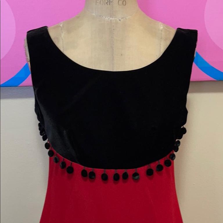 Moschino cheap chic red black velvet party dress

This vintage party dress is absolute perfection with black velvet bodice with tiny tassels. Red acetate crepe bottom in a nice A line style. Very 1960s retro vibe. Dress is from 1990s. Add black knee