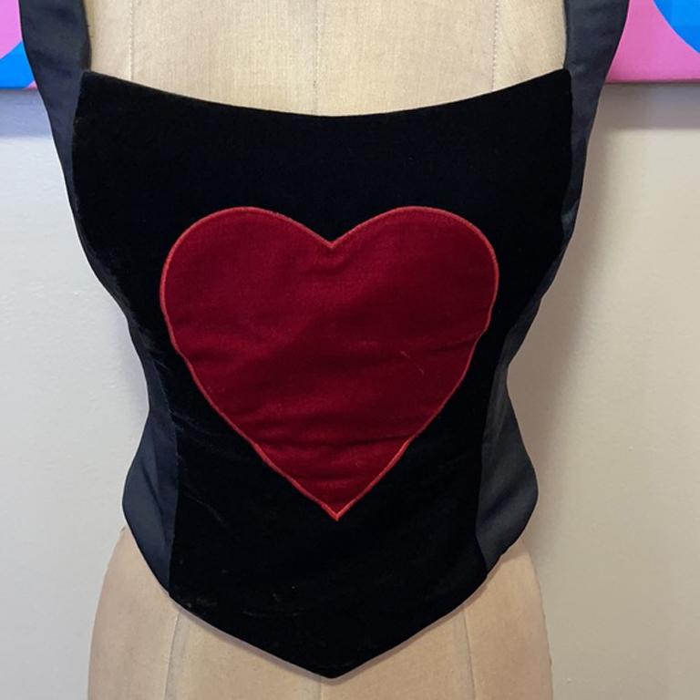Moschino cheap chic velvet heart bustier

Bustier's are all the rage with the popularity of streaming shows showing historic dressing. Pair this with black skinny pants or a pencil skirt for a finished look.
You can also wear over a ruffle shirt.