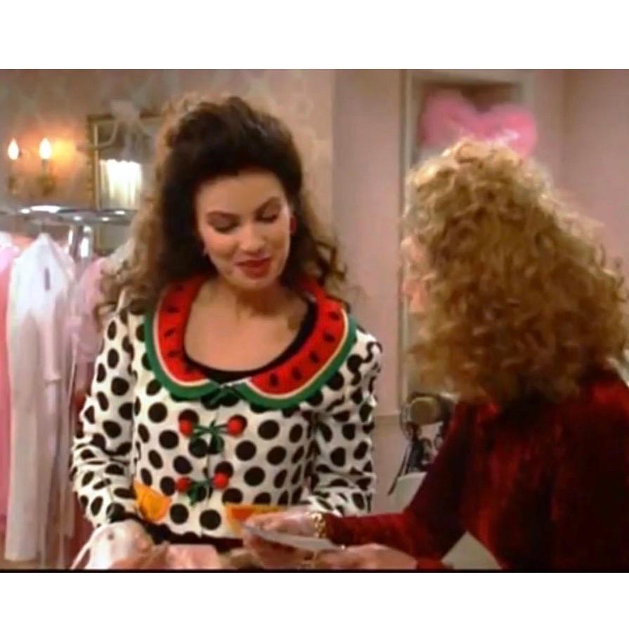 Highly collectable and iconic 1990's Moschino Cheap & Chic polka dot fruit appliqué jacket as seen on Fran Dresher in The Nanny.
This jacket features a whimsical design with white polka dots against a black background and colorful large orange slice
