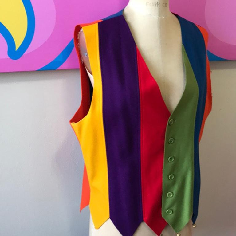 Moschino cheap chic wool vest rainbow bells

Stand out this holiday season wearing this vintage wool vest from Moschino. Bells at the bottom and bright colors signal fun! Unlined. A few imperfections in the wool in front with some small stains and a