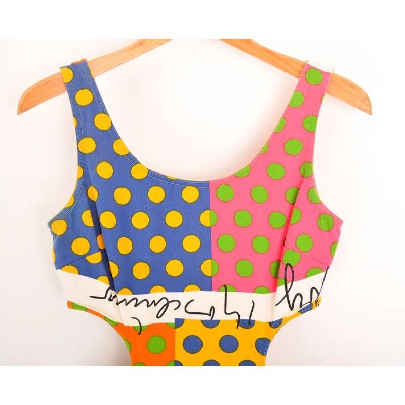 Fabulous 1990's Vintage Moschino Polka Dot patterned mini dress in a vibrant pop arty, colourful print featuring cut out side .

Features;
Front pockets
Concealed zip up the back
Vibrant pop art print
Cut out waist design

100% Cotton

MADE IN ITALY