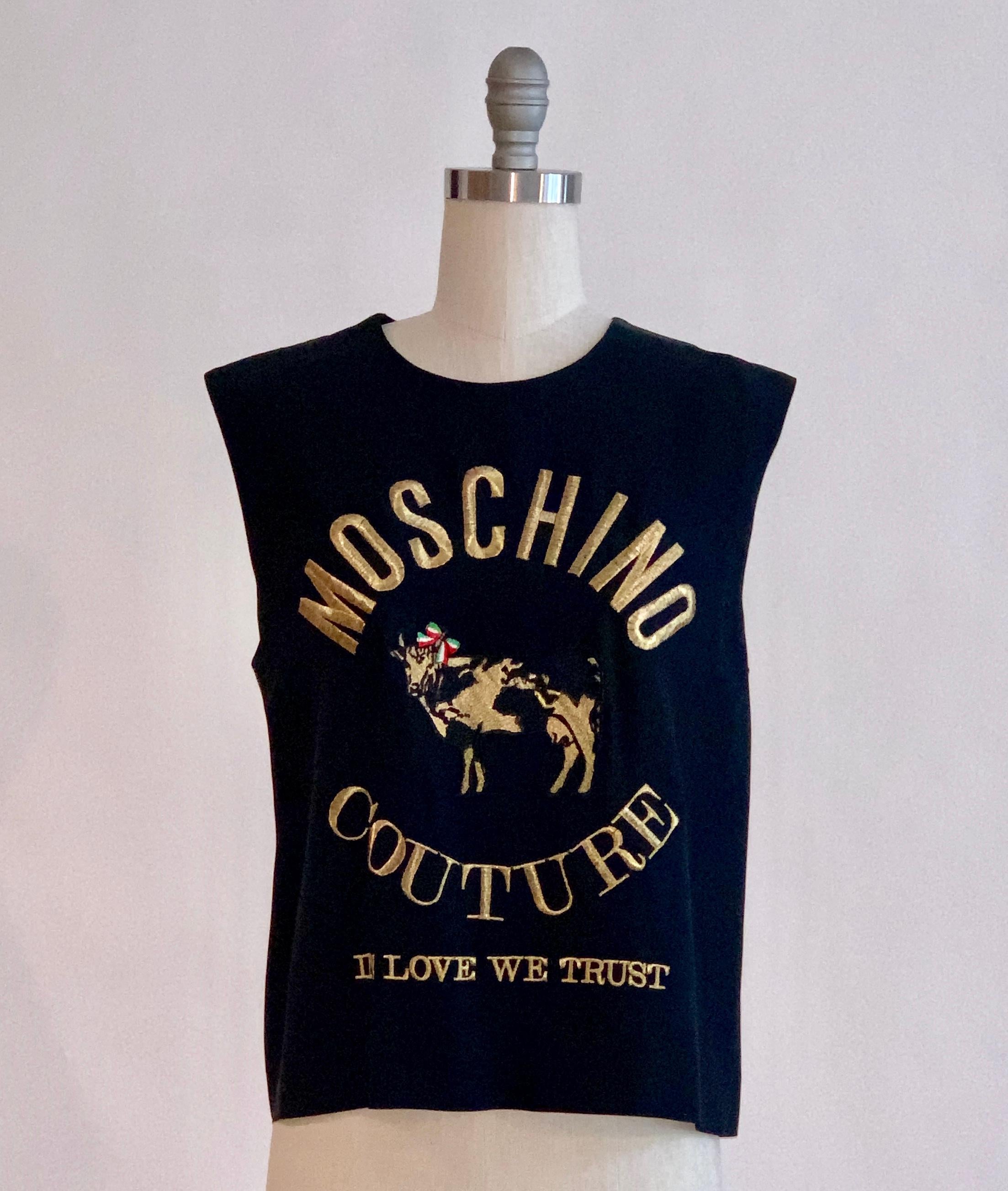 Moschino Couture vintage 1980s sleeveless blouse with In Love We Trust and a cow with an Italian flag colored bow embroidered in gold at front. A super iconic Moschino design! Deep navy (almost black.) Short zipper at back neck. 

50% acetate, 50%
