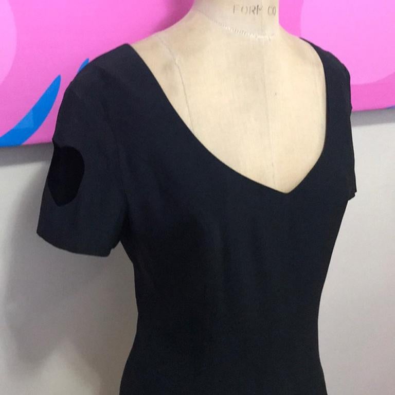 Moschino couture black cut out heart top

This vintage top from Moschino Couture is a super fun piece for special occasion dressing. Pair with simple black pants and heels for a nice look. Cut outs in a heart shape in each sleeve is iconic Moschino!