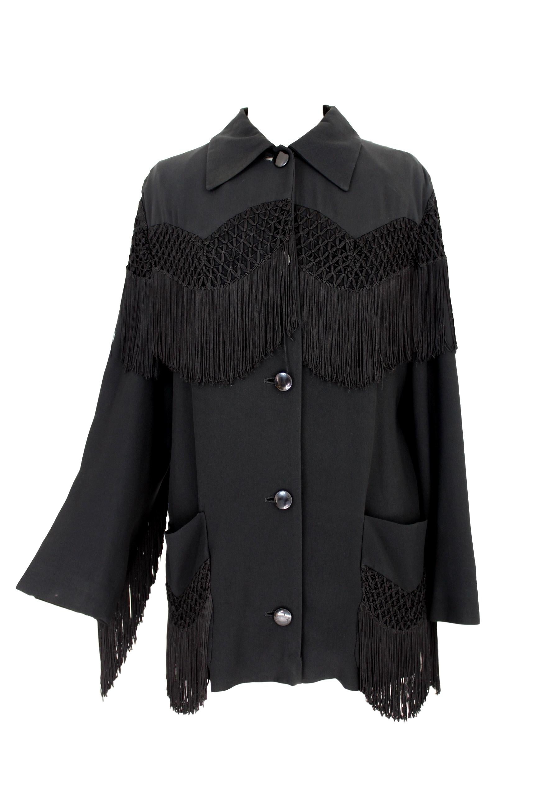 Moschino Couture vintage 80s women's jacket. Model western with long fringe, both on the length of the jacket and on the sleeves with embroidery on the chest. 55% acetate 45% rayon. Internally lined. Made in Italy. Excellent vintage