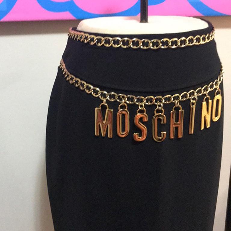 Moschino couture black gold chain charm skirt

Unique chain and charm details on this skirt make it a standout ! Show your fun side with this skirt paired with a turtleneck sweater and knee high boots for Fall .  No pockets.
Size 12
Across waist -