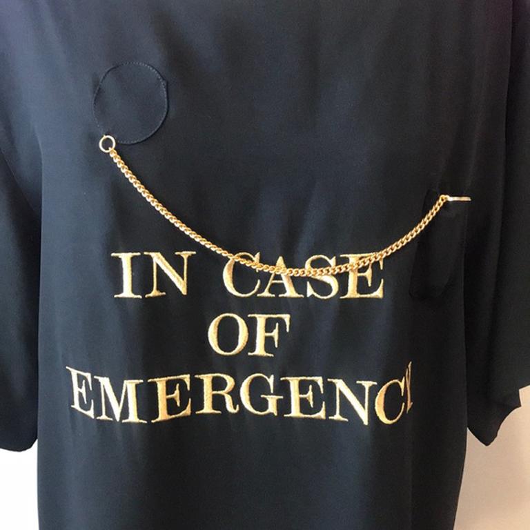 Moschino couture black gold whistle top

Moschino Couture's sense of humor is evident in this IN CASE OF EMERGENCY shirt with gold chain and whistle. The inside lining at the neck tends to turn out see last picture. Rare! Great for the