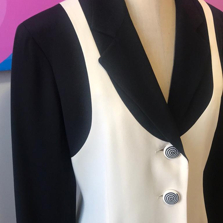 Moschino couture black ivory blazer

Moschino Couture makes a unique statement with this color block blazer and buttons with spiral design sure to make you sleepy ! 
Size 10
Across chest - 18 1/2 in,.
Across waist 16 in.
Shoulder to hem - 27 1/2
