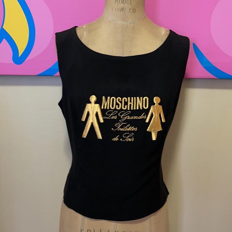 Moschino couture black les grandes toilettes top

Moschino bring a sense of humor to the forefront with this fun top! Pair with black skinny pants or pencil skirt for a finished look. Thin enough material to wear under blazers. Size 12.

Across
