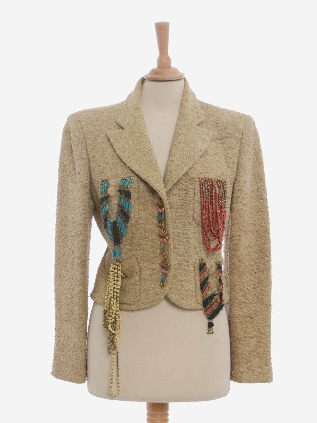 Moschino Couture Blazer With Pendants Decorations is a rare jacket featuring a textured woven silk fabric, three jewel button closure and four front pockets from which hang various decorations made of semi-precious stones and metal