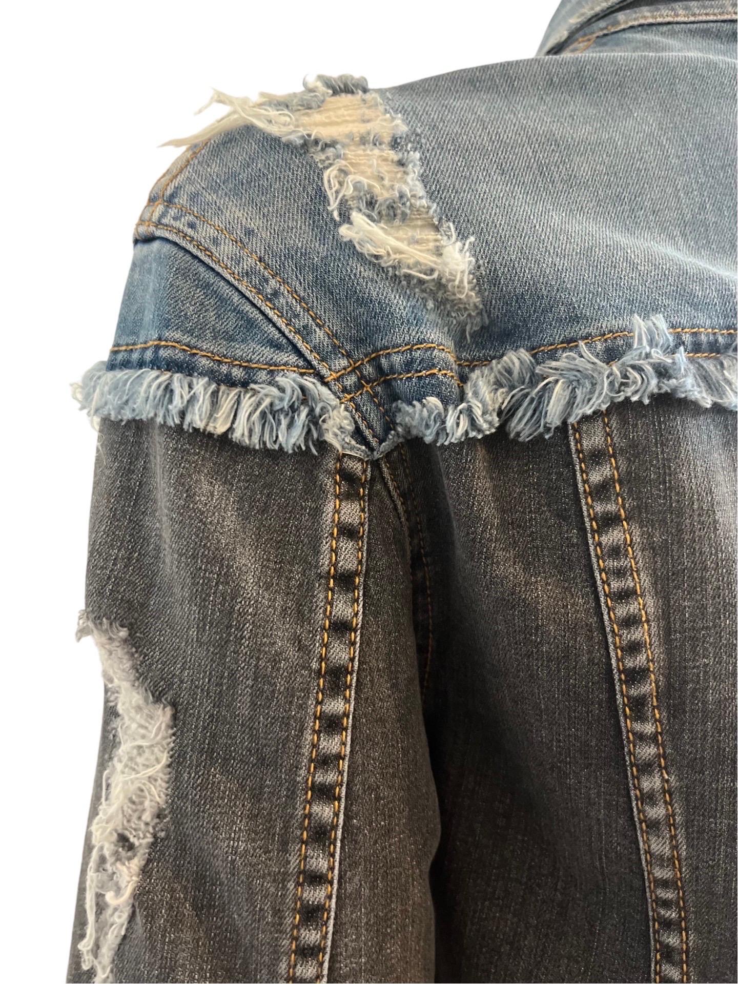 Modern Moschino Couture two tone denim jacket with intentionally destroyed areas on the shoulders and in other areas.  Two front pockets and buttons to fasten the front. 

Still has the tags on it. 

Length 20