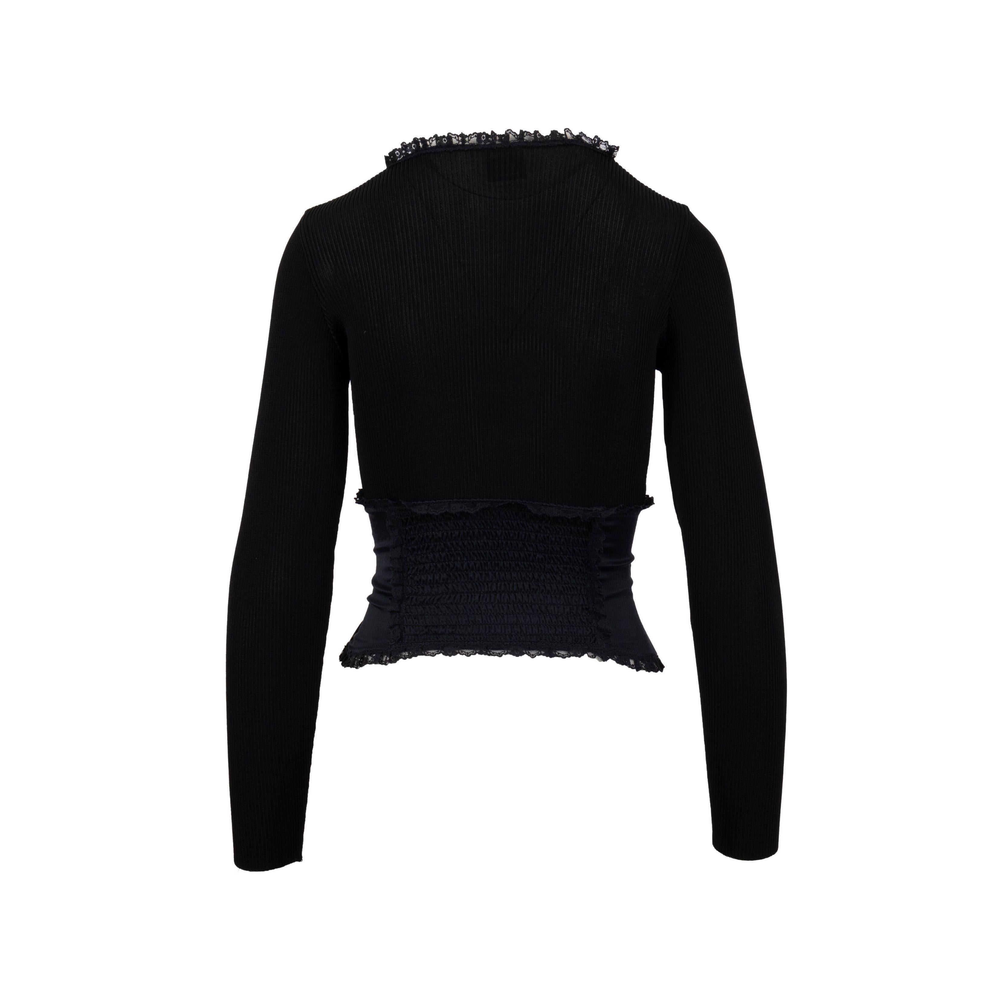 Crafted with a ribbed knit and featuring lace details on the deep round neck and long sleeves, the added corset provides a snug fit and is made of shiny silk with lace frills and string detailing. The back of the waist is ruched for a flattering