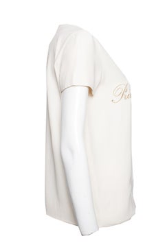 Moschino Couture, Cream-colored top with gold text.