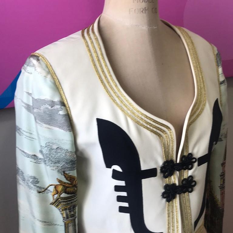 Moschino couture cropped silk jacket

Iconic Moschino Couture! This silk cropped jacket is from the Cruise Me Baby Collection. Embroidered Lion on the back and cuffs. Some gathering of fabric at embroidery. A tiny spot on front.  Pair with black