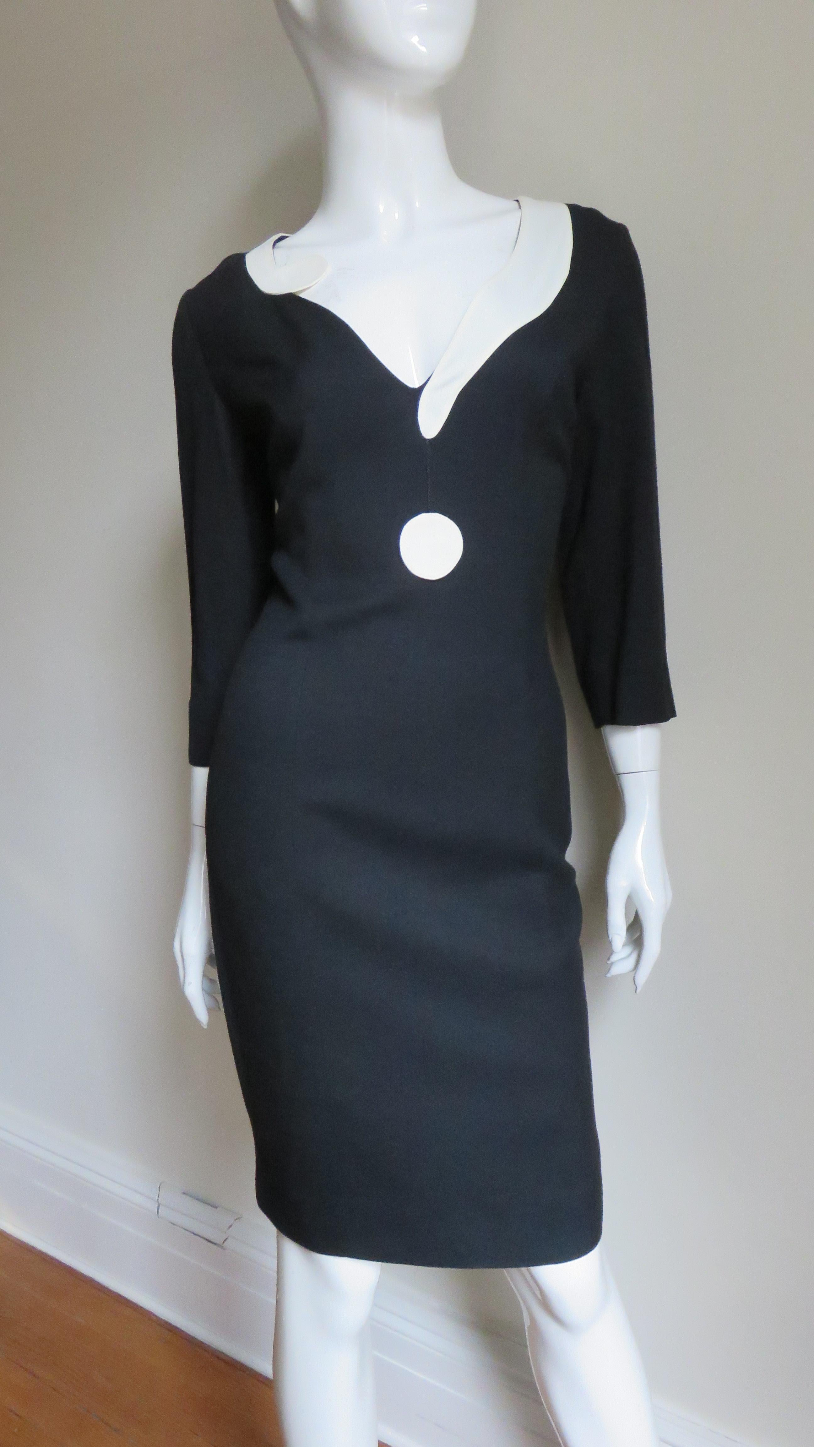 A fabulous black dress encircled around it's V neckline with an off white question mark with the dot of the question mark dangling cleverly below it.  The dress has 3/4 length sleeve and is semi fitted  with princess seaming for a great fit.  It is