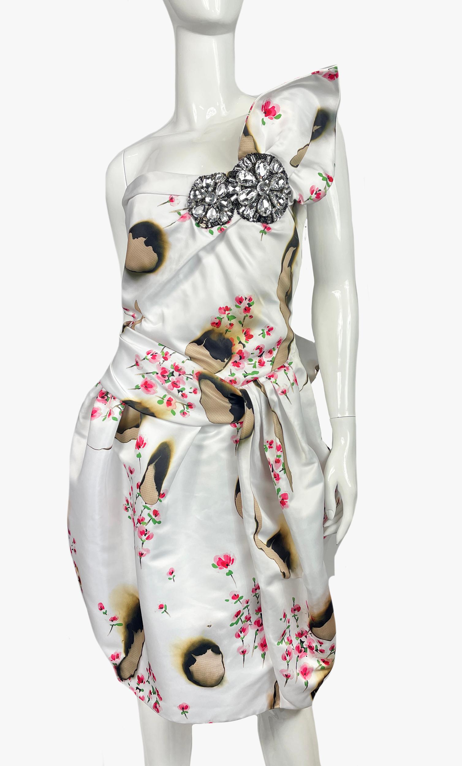 Stunning Moschino Couture floral print dress with beaded, sequin and crystal accents. Sleeveless with one-shoulder, concealed zip closure at side.
Period; 2000s
Fabric: 100% Polyester; Lining 60% Acetate, 40% Rayon; Combo 82% Nylon, 18%