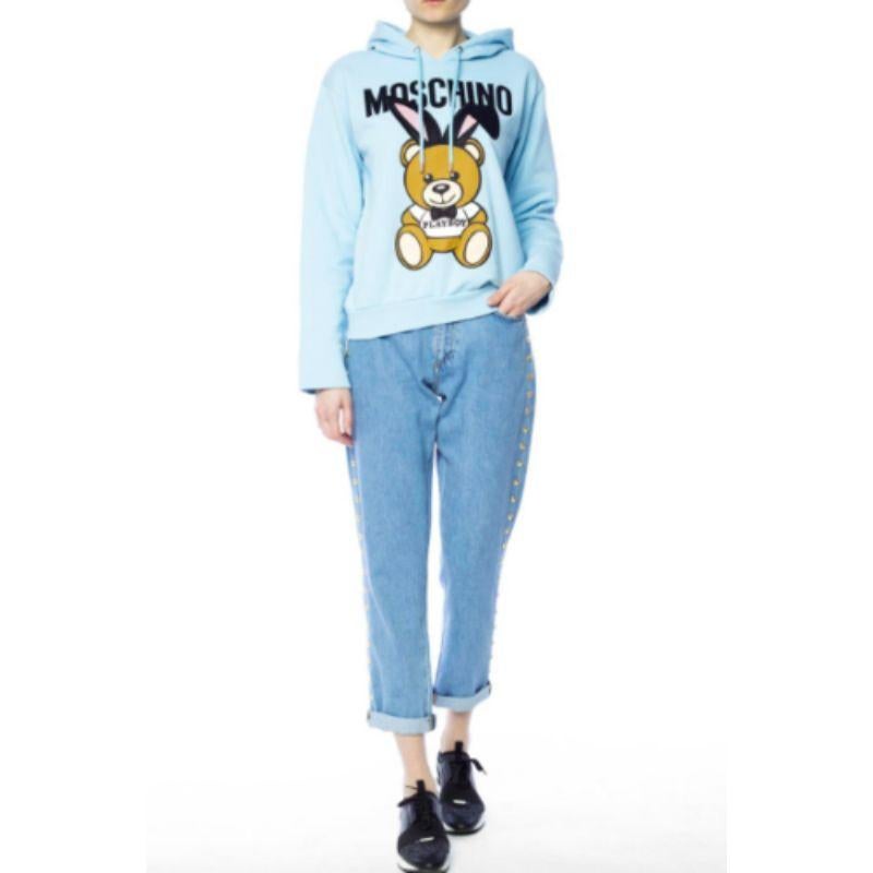 Moschino Couture Jeremy Scott Teddy Bear Playboy Blue Sweatshirt Hoodie 3D Pompo

Additional Information:
Material: 100% Cotton (outer). Acetate 63% viscose 37%
Color: Light Blue / Multi-color
Pattern: Playboy Teddy Bear Bunny
Style: Hoodie
Size: