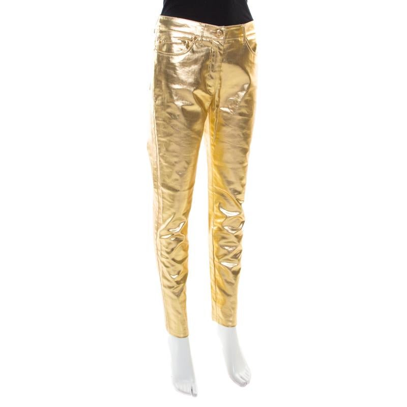 Sure to be an amazing addition to your collection, these jeans from Moschino couture are a must buy! TThe metallic gold jeans are made of a cotton blend and feature a tapered bottom silhouette. They flaunt a front button fastening, belt loop