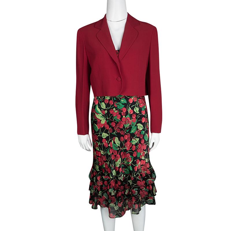 From the house of Moschino comes this gorgeous set that has a dress and a blazer. The dress has cherry prints all over with ruffles at the bottom and the blazer has a cropped style with front buttons. This set can be worn with a pair of simple