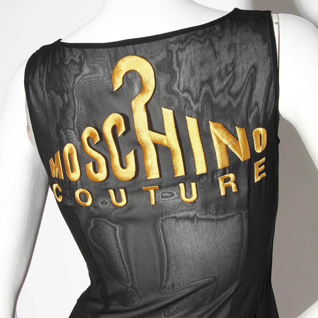 Moschino Couture Sheath Dress
Vintage 
Circa 1980's 
Made in Italy 
Embroidery detail in gold thread on bust 
Moschino Couture with Hanger detail on front of bust 
Sheer chiffon panel bust 
Black 
Invisible zipper right side of dress 
Knee length