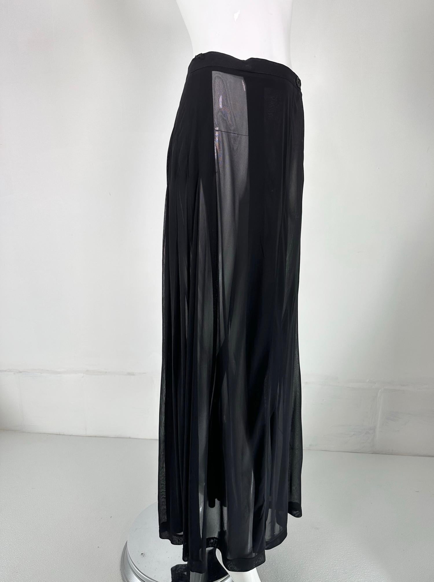 Moschino Couture sheer black wrap front pleated maxi skirt from the 1990s. Sheer black rayon chiffon skirt with a narrow waist band that wraps & closes at the waist front with buttons. The front panels over-lap from the skirt sides to the front. The