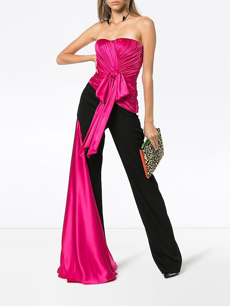 Moschino Couture jumpsuit specially designed with dramatic exciting eye catching presence!  Ruched rich rose magenta silk bodice with  fine black wool tux style trousers. Boned bodice with interior bra. Side zipper closure.  Single hip pocket; with
