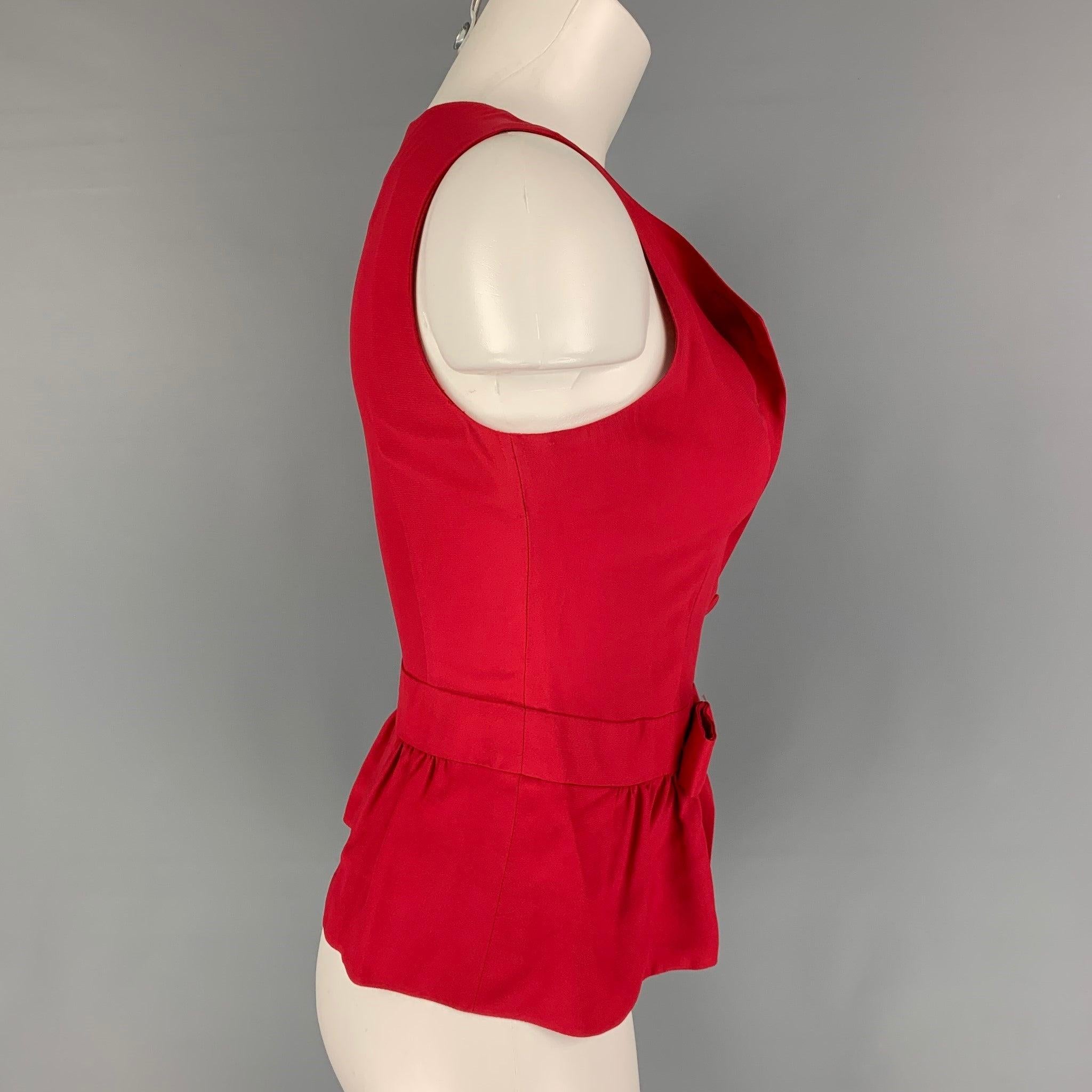 MOSCHINO COUTURE blouse comes in a red acetate / rayon featuring a sleeveless style, front bow detail, side zipper, and a front button closure. Made in Italy.
Very Good
Pre-Owned Condition. 

Marked:   I 42 / D 38 / F 38 / GB 10 / USA 8 
