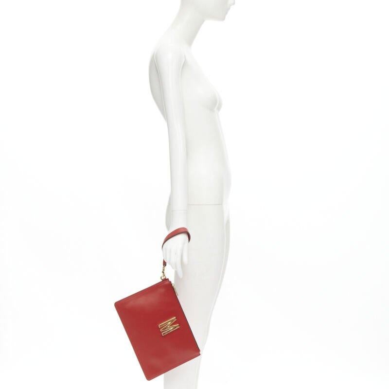 MOSCHINO Couture! smooth red leather gold M top zip wristlet clutch bag
Reference: KNCN/A00020
Brand: Moschino
Designer: Jeremy Scott
Collection: Spring Summer 2020
Material: Leather
Color: Red, Gold
Pattern: Solid
Lining:  Fabric
Extra Details: