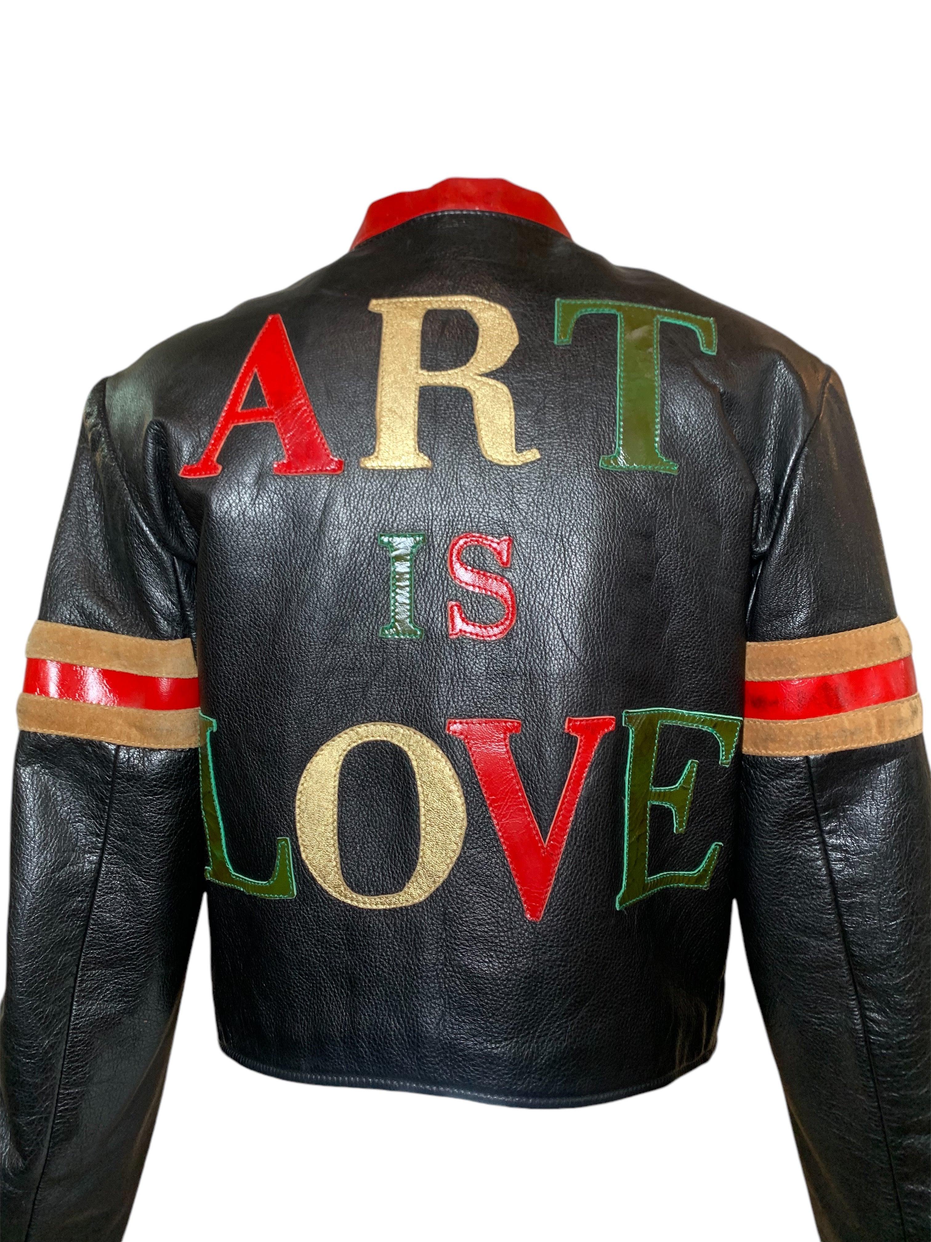 A rare and highly collectible Moschino Cheap and Chic leather jacket from their Fall/ Winter 1990/1991 collection. Glossy black pebbled leather with patches of metallic gold leather, patent red leather, patent olive green leather, and tan suede. The