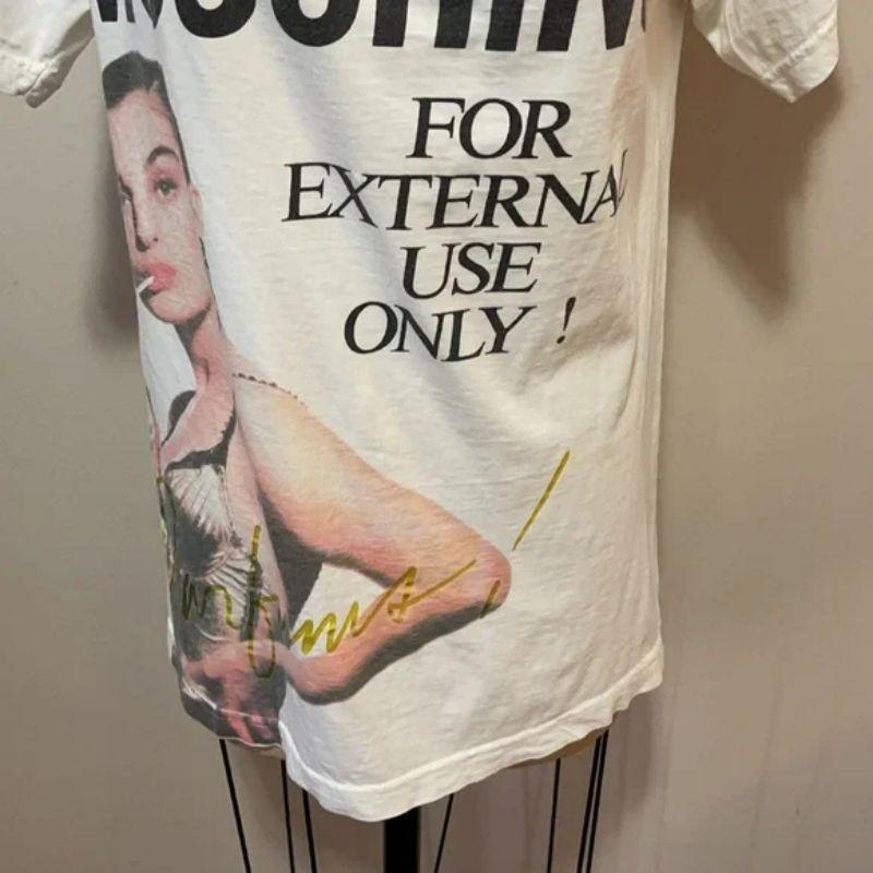 Moschino for external use only t-shirt

Moschino Parfums had a promotional campaign that had women drinking perfume through a straw with the warning - FOR EXTERNAL USE ONLY on the bottle./ ad campaign. This is from that promotional campaign. This
