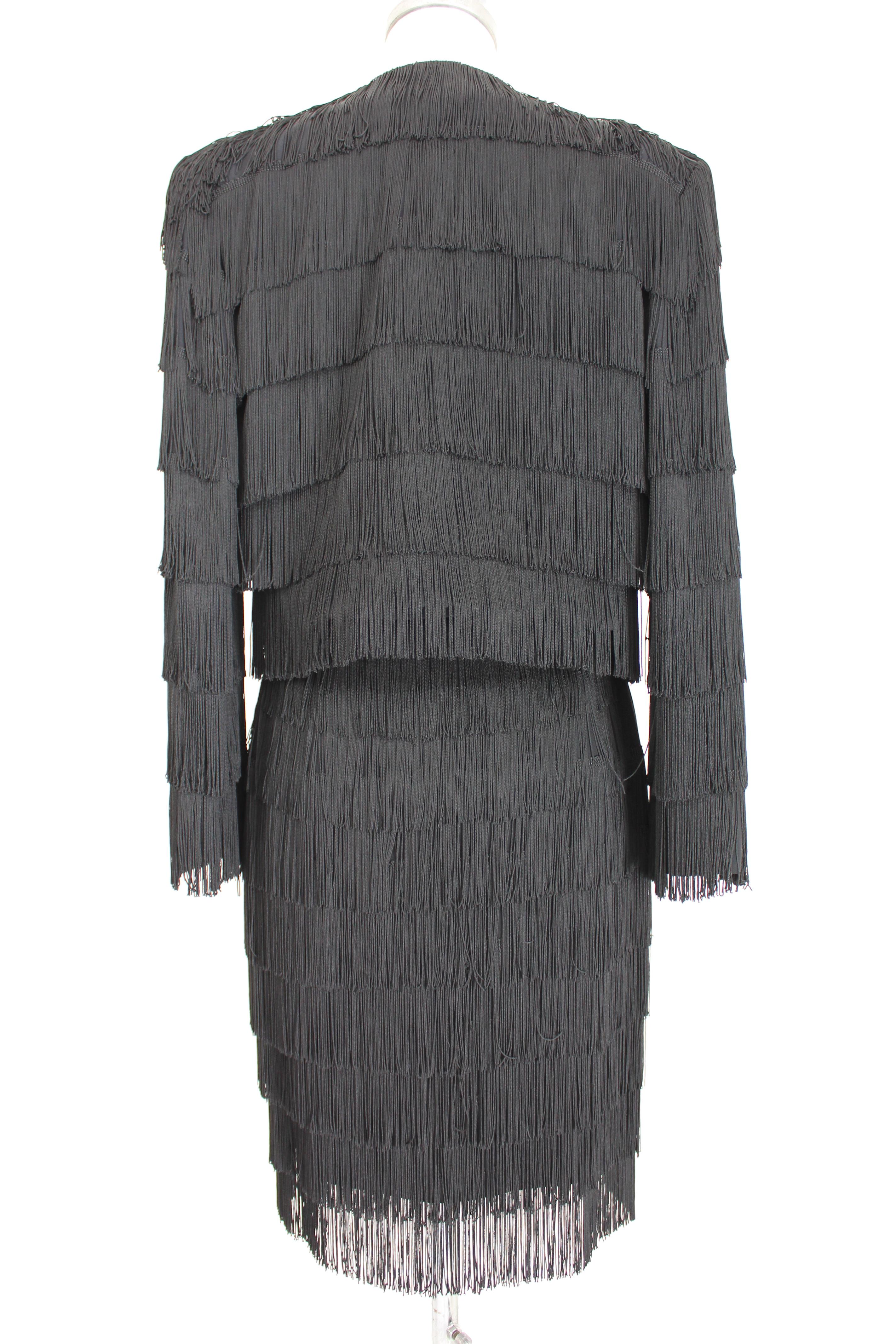 Moschino Couture 90s vintage women's suit. Evening jacket and skirt, black, covered with charleston-style fringes. Straight pencil skirt, short bolero-style jacket. Fabric 55% acetate 45% rayon, internally lined 100% rayon. Made in Italy. Excellent