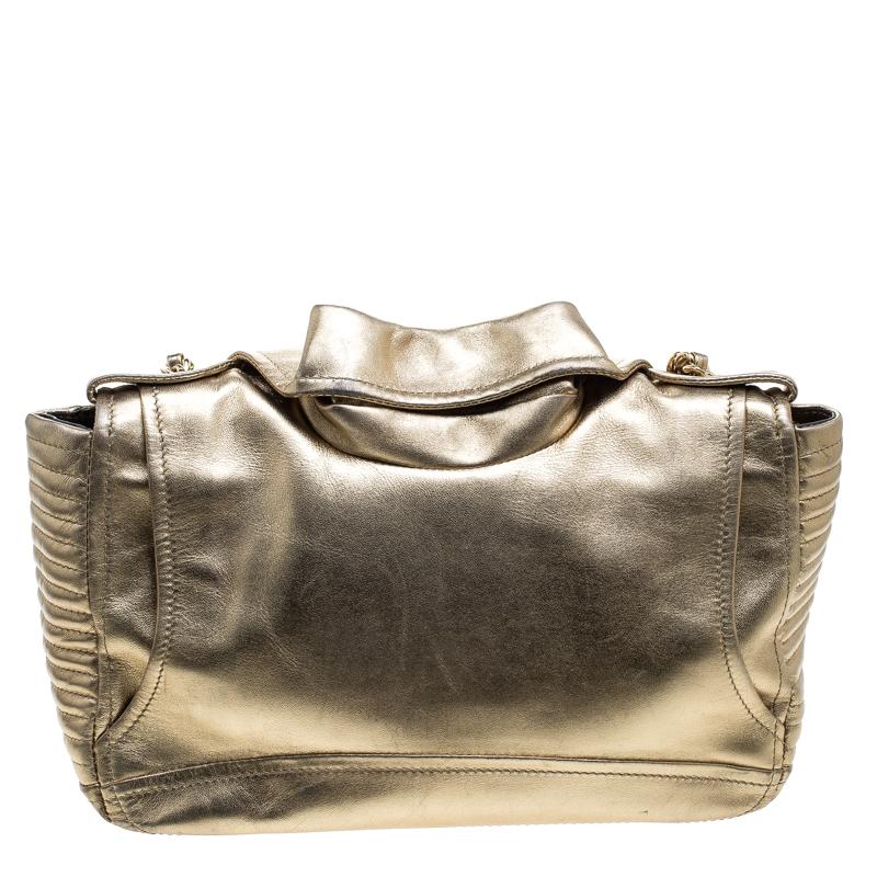 From Moschino's SS15 capsule collection, comes this upbeat shoulder bag that is like no other bag we have laid eyes on. So cleverly interpreted, the bag is basically a biker jacket to be worn on your shoulder. It has zippers in gold tone, snap