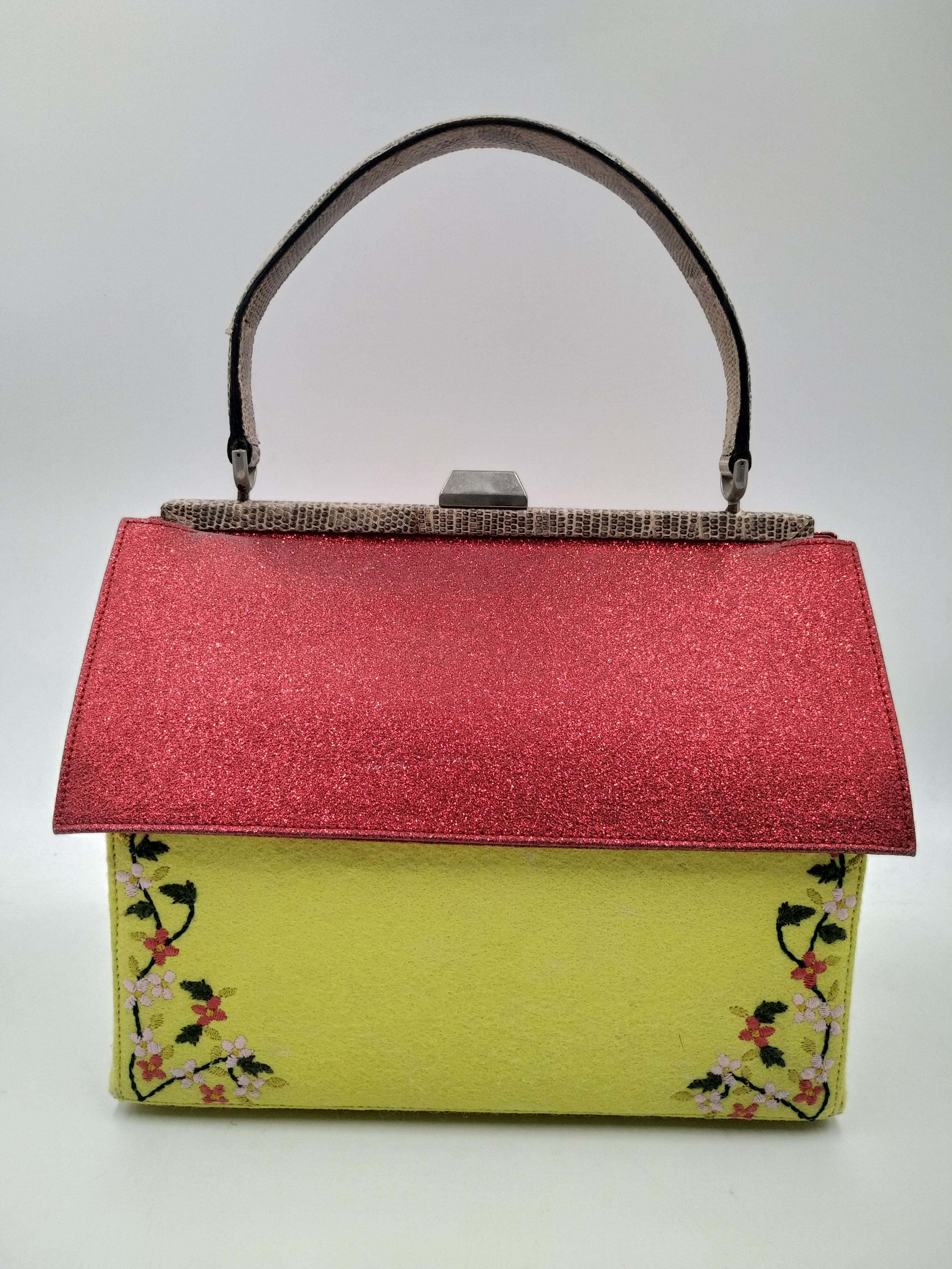 Moschino Hansel and Gretel gingerbread house bag, limited edition 2000
- 100% authentic Moschino
- Red lamé roof, pink python for the front door and yellow suede walls
- Front door that opens to conceal a mirror
- metal push-lock clasp
- protective