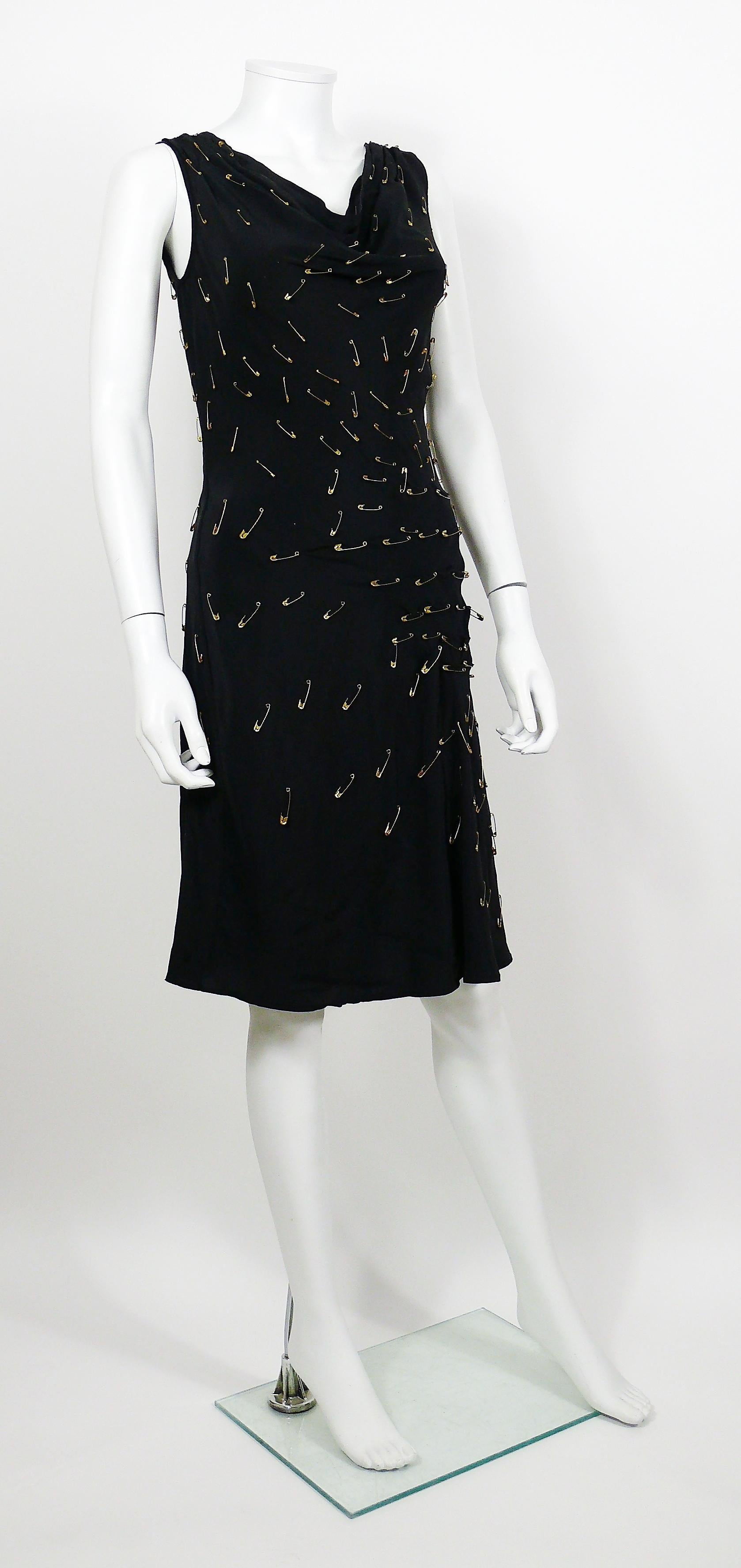 MOSCHINO iconic safety pin embellished black dress as worn by KATE MOSS.

Label reads MOSCHINO CHEAP AND CHIC.

Size tag reads : I 42 / D 38 / F 38 / GB 10 / USA 8.
Please refer to measurements.

Composition tag reads : 100% Silk.

Indicative