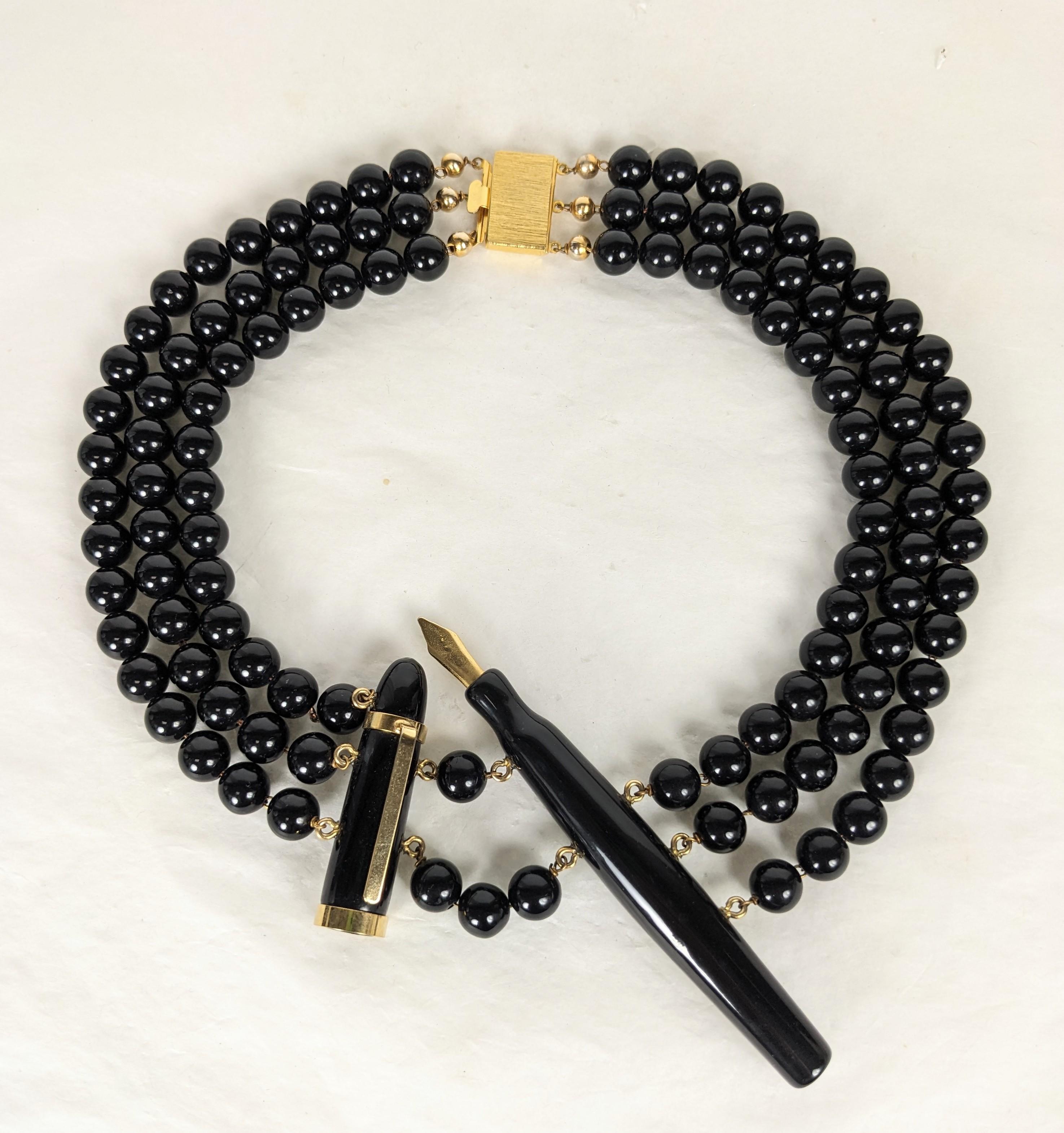 Wonderful and Rare Moschino Iconic Pen Necklace from the 1990's made by Ugo Correani who specialized in bakelite and resin jewels for the top fashion houses. Incredibly crafted as a suspended vintage ink pen and cap strung on 3 strands of