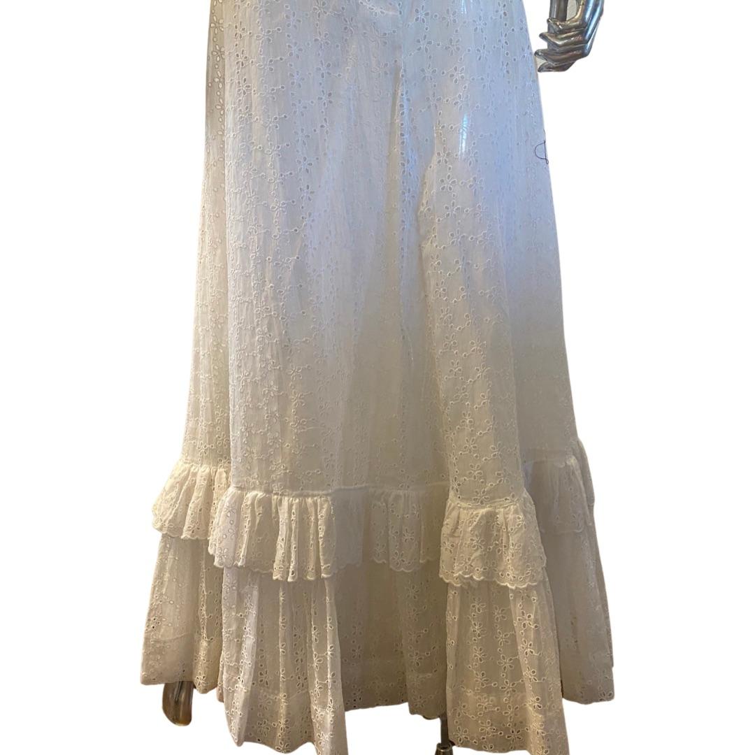 This is the most romantic summer skirt. Designed by house of Moschino before the Jeremy Scott era, the European eyelet outer skirt has a double layer ruffle at hem. It could be used alone or with the solid white solid organza petticoat. Even the