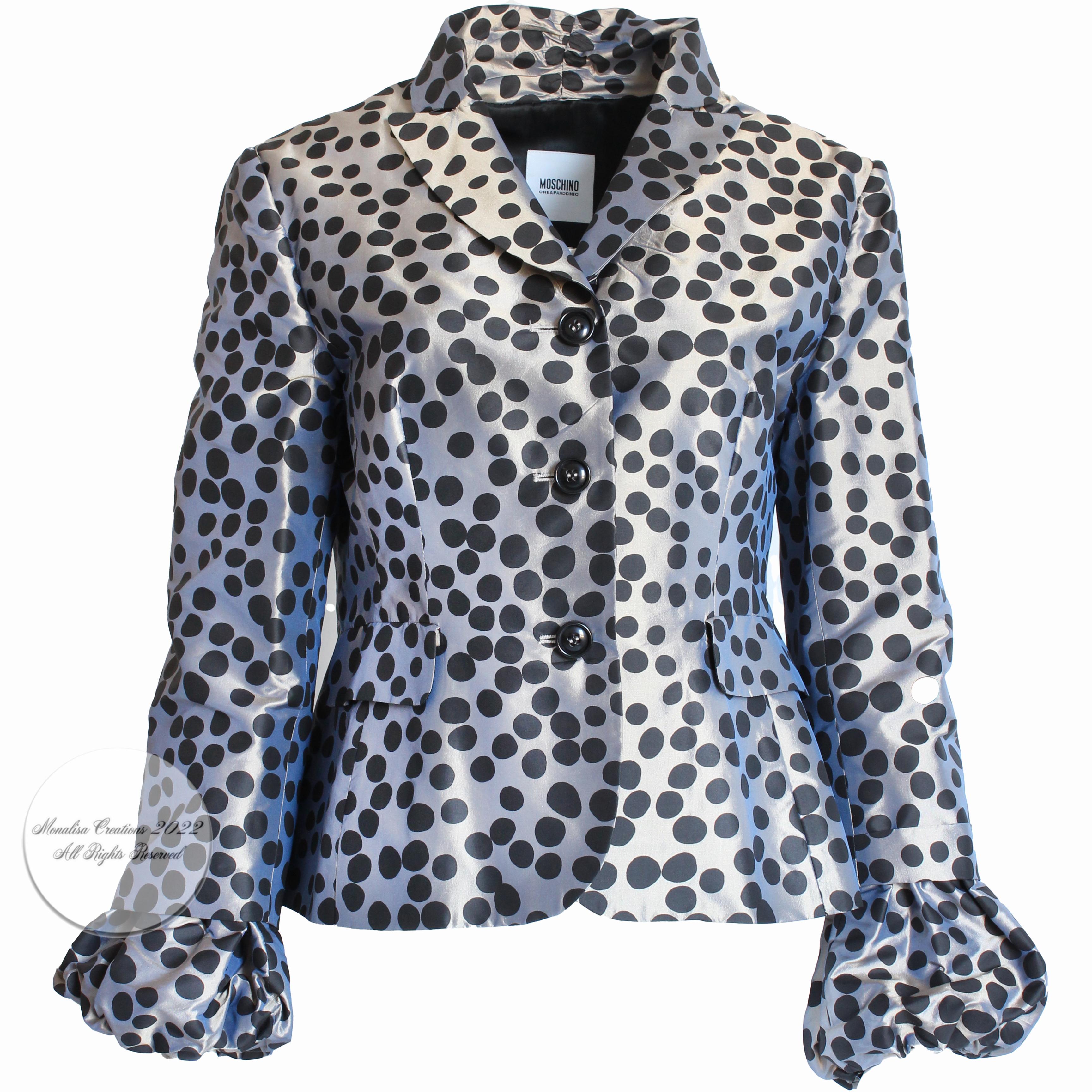 Authentic, preowned Moschino jacket, likely made in the late 2000s for their Cheap and Chic line.  Made from a gunmetal-silver silk fabric with black polka dots, it features elasticized puff sleeve cuffs and a flared hem.  

Fabulously chic and so