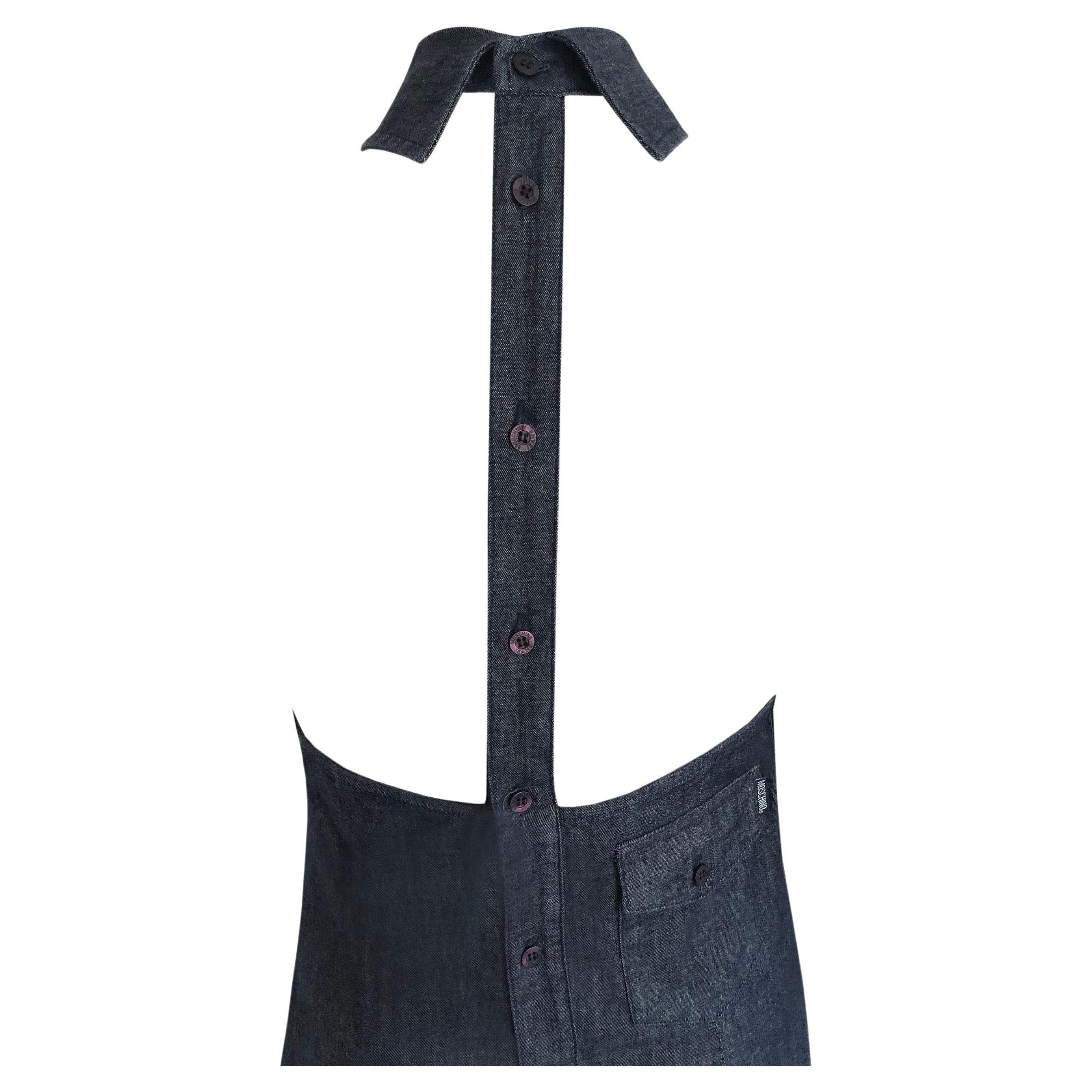Product Details: Moschino Jeans - Denim Halter Neck Dress - Button Through Backless Strap Detailing - Knee Length - Gathered Front Neckline Detail - Back Pocket + Moschino Tab 
Label: Moschino Jeans 
Size: US 12 (Fits UK 8 to UK 12)
Fabric Content: