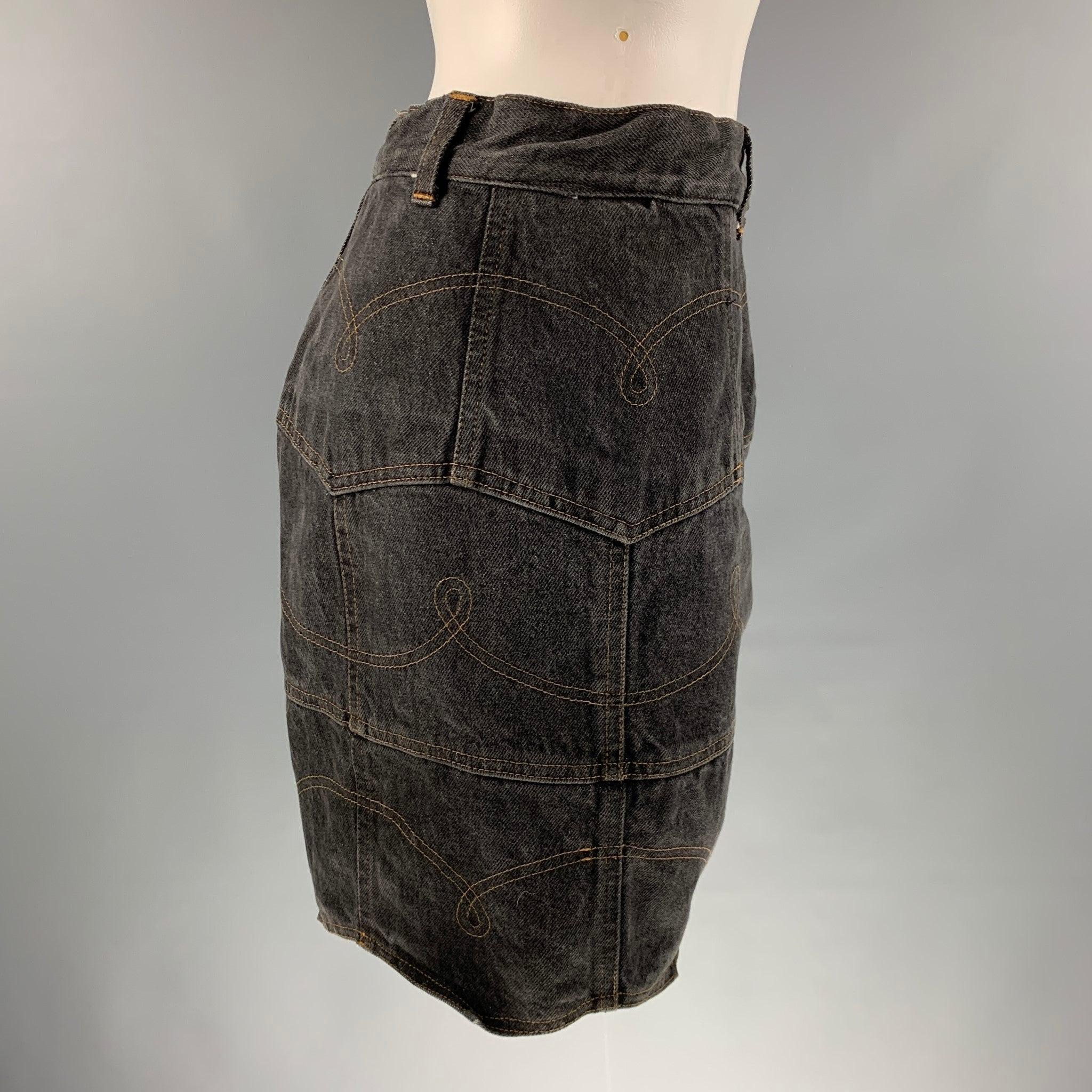 MOSCHINO JEANS skirt comes in a black denim a full liner featuring a mini skirt style, pockets texture, contrast stitching, and a zip up closure. Very Good Pre-Owned Condition. Moderate Signs of wear and Tags removed. 

Marked:   no size marked.