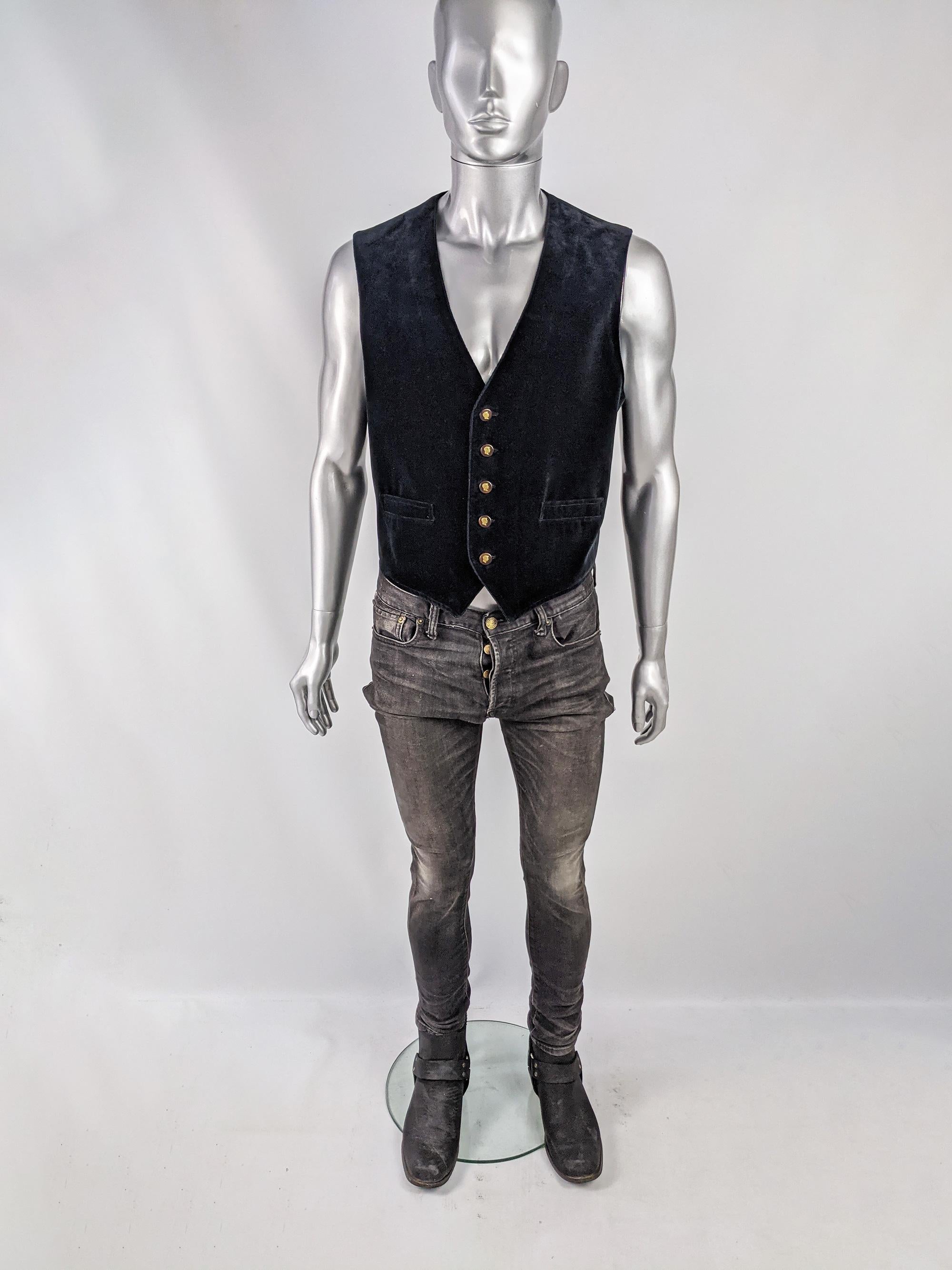 A stylish and understated vintage mens Moschino waistcoat from the 80s for his early menswear line, 'Uomo'. In a classic black velvet with buttons embellished with Franco Moschino's cameo adding a touch of the whimsy that he was known for. Perfect