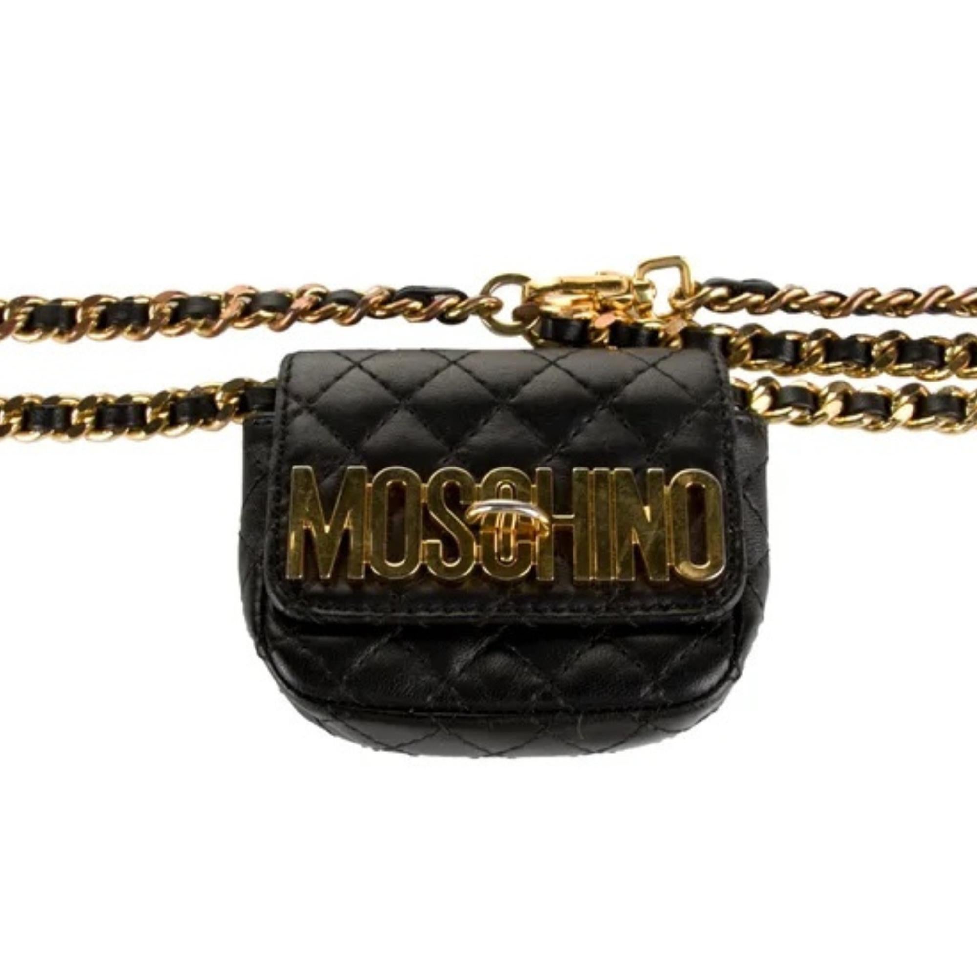 This Moschino belt bag features black leather, quilted stitch, gold-tone hardware, a wrist strap, logo jacquard lining and turn-lock closure at front.

Color: Black
Material: Leather
Measures: H 3.5” x L 3.75” x D 1”
Chain length: 48”
Condition: