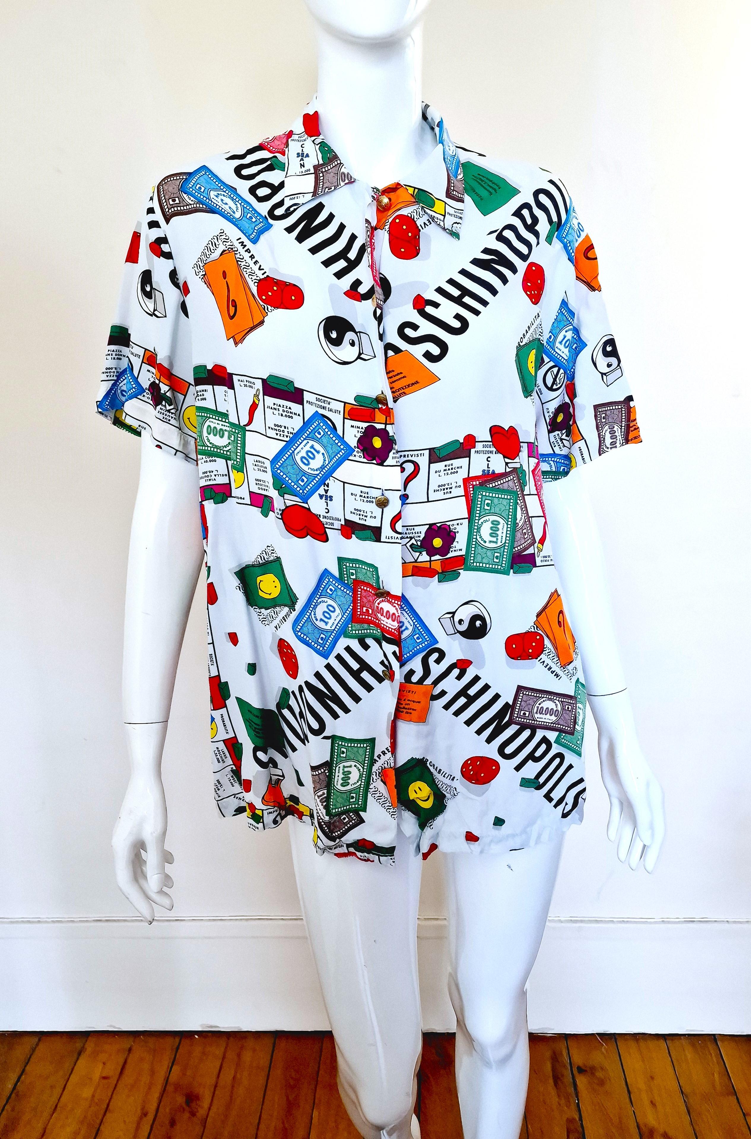 Moschinopolis shirt (Monopoly board game) by Moschino!
Peace symbol metal buttons.

VERY GOOD condition!

SIZE
Women: large (but if you do not mind oversize look, it can fit from XS).
Men: medium.
Marked size: IT42 / USA8 / FR38  / GB12  /