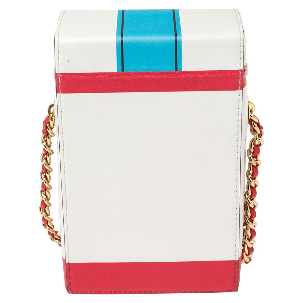 Contemporary and edgy, this bag from Moschino is sure to set you apart! It is crafted from multicolor leather in the shape of a cigarette box and styled with the brand logo and 'Fashion Kills' details on the front. It is equipped with a chainlink