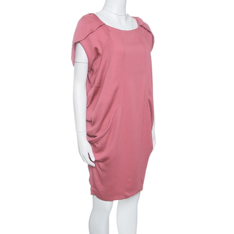Cut to a comfy structure with relaxed short sleeves and knee-length, this Moschino dress is an excellent evening choice. It features a draped pattern on each side and is adorned with faux cowl detail on the shoulders. Wear this with complementing