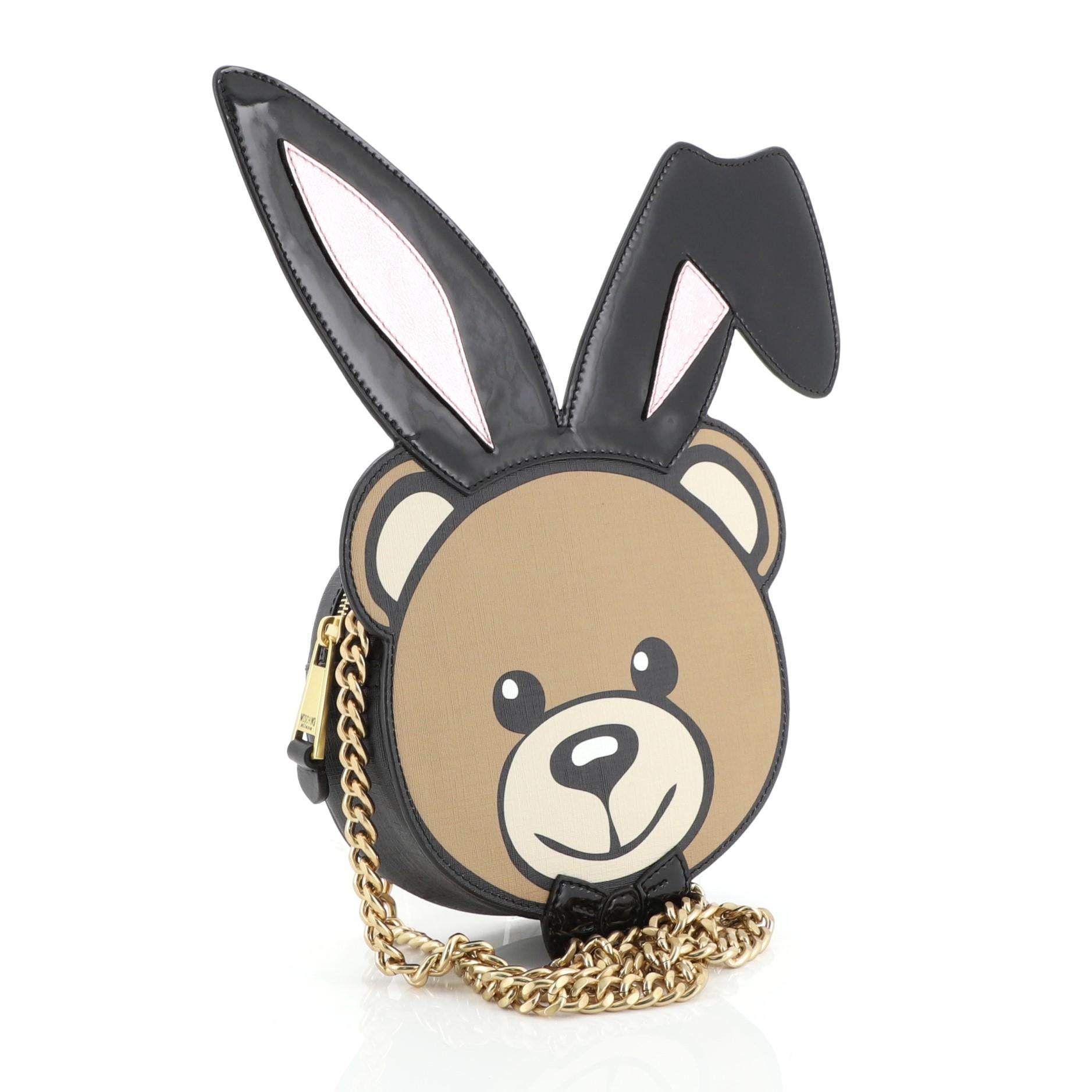 This Moschino Playboy Bear Chain Crossbody Bag Leather with Patent Small, crafted in neutral multicolor leather with black patent, features chain link strap, bear with playboy bunny ears design, and matte gold-tone hardware. Its zip closure opens to